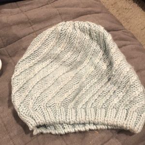 Aqua cable knit beanie with silver stitching.